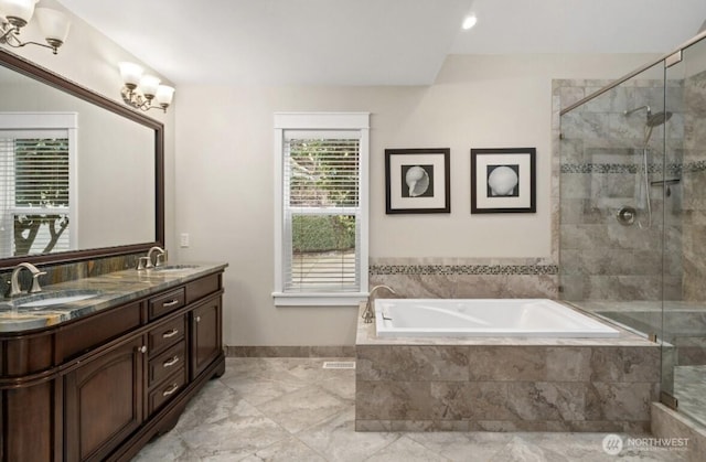 full bathroom featuring a shower stall, a bath, double vanity, and a sink