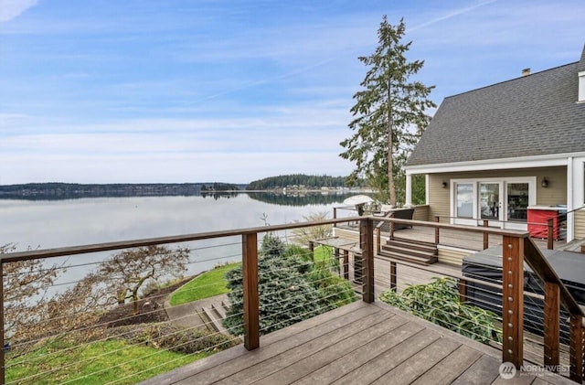 wooden terrace featuring a water view