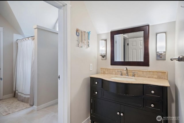 bathroom featuring vanity, a shower with curtain, baseboards, lofted ceiling, and decorative backsplash