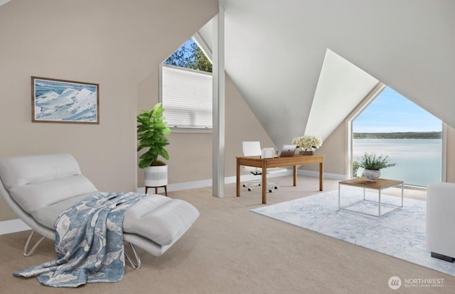 living area with vaulted ceiling, carpet flooring, baseboards, and a water view