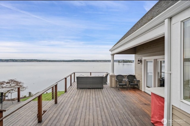 wooden deck featuring a water view