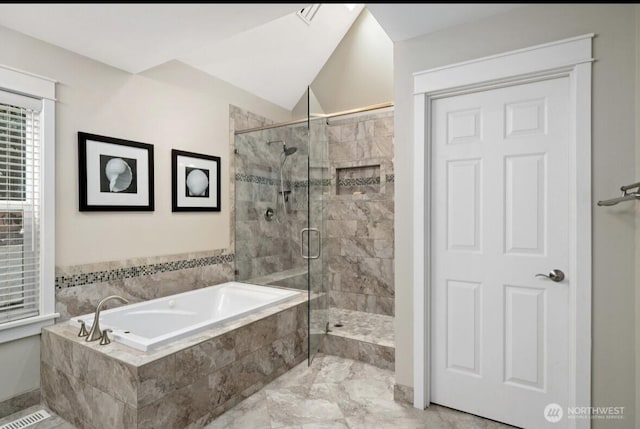 bathroom with a shower stall, marble finish floor, a garden tub, and lofted ceiling