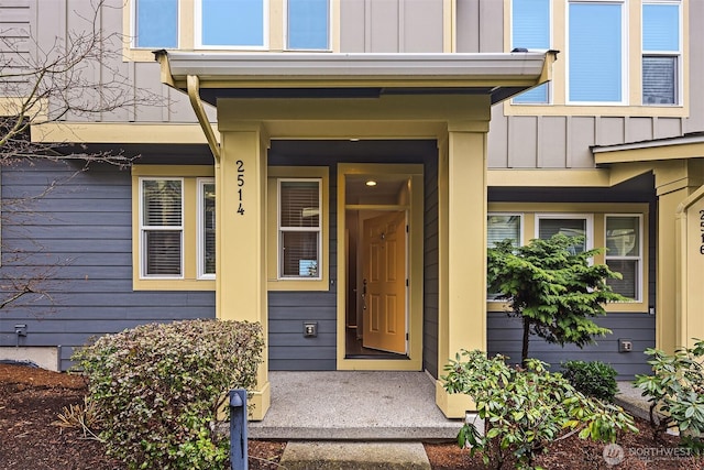 property entrance featuring board and batten siding