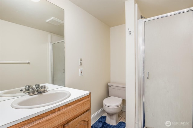 bathroom with vanity, toilet, and a shower stall