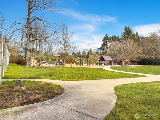 view of home's community with a lawn and playground community