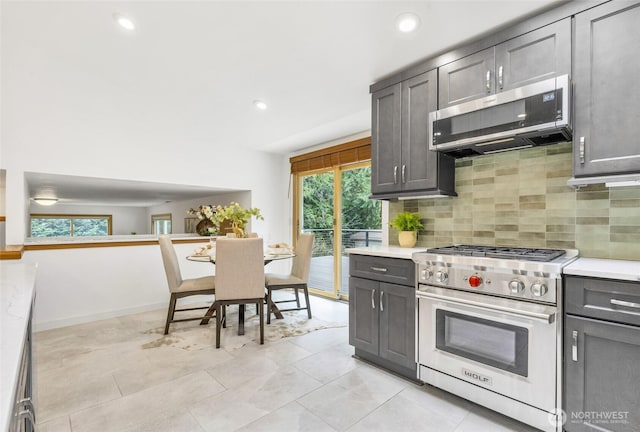 kitchen with tasteful backsplash, recessed lighting, appliances with stainless steel finishes, and light countertops