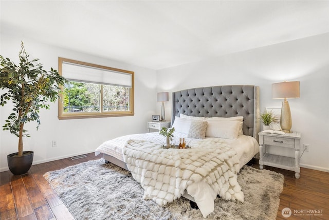 bedroom featuring hardwood / wood-style flooring and baseboards