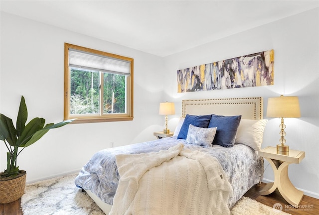 bedroom with wood finished floors and baseboards