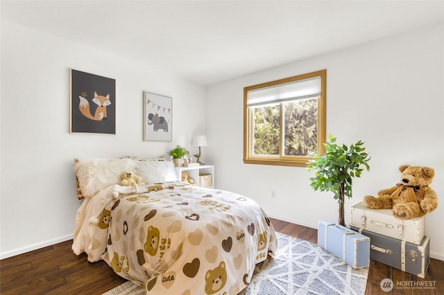 bedroom featuring wood finished floors and baseboards