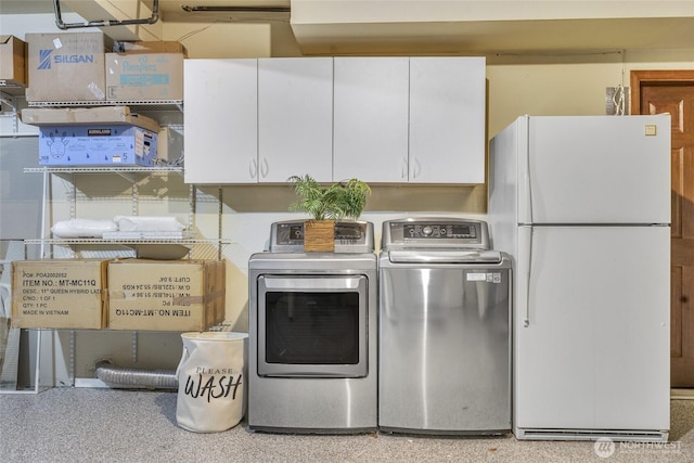 laundry room featuring cabinet space and washing machine and clothes dryer