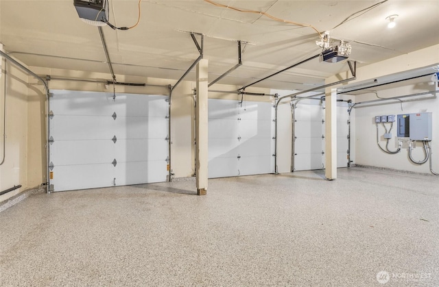 garage featuring electric panel and a garage door opener