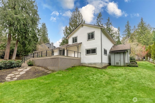 rear view of house featuring a deck and a yard