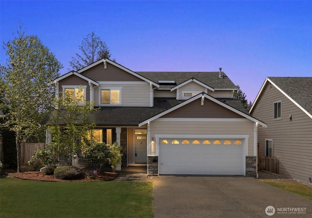 view of front of house with roof mounted solar panels, fence, concrete driveway, a front yard, and an attached garage