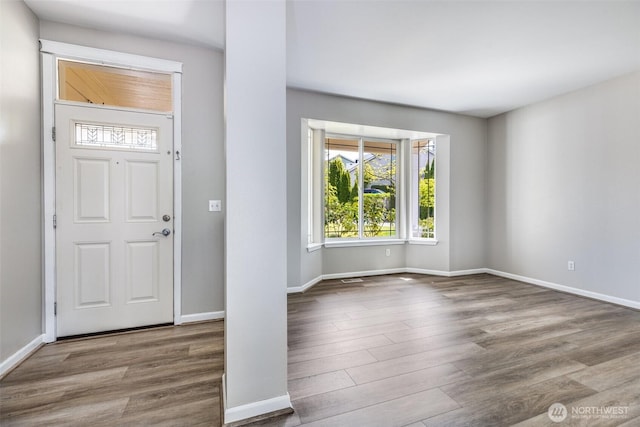 entrance foyer featuring wood finished floors and baseboards