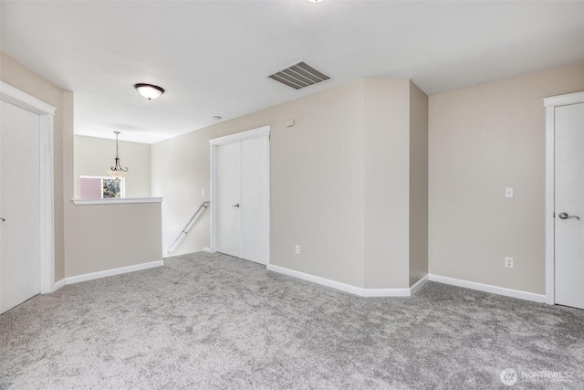 unfurnished room featuring carpet flooring, baseboards, and visible vents