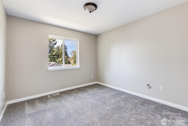 carpeted empty room with visible vents and baseboards