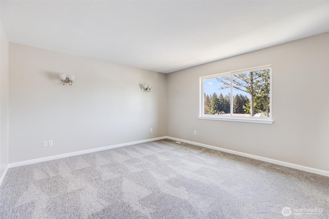 carpeted spare room with baseboards