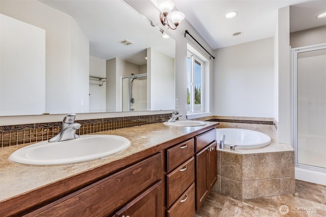 full bath featuring visible vents, a shower stall, a garden tub, and a sink