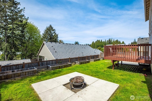 view of yard with a patio, a vegetable garden, fence private yard, and an outdoor fire pit