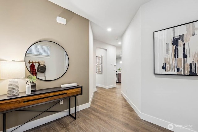 hallway with recessed lighting, baseboards, and wood finished floors