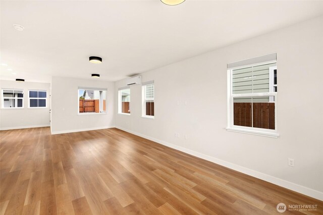 spare room featuring light wood-style flooring and baseboards