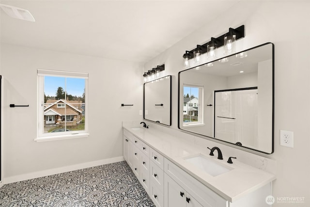 full bathroom featuring a sink, visible vents, baseboards, and double vanity