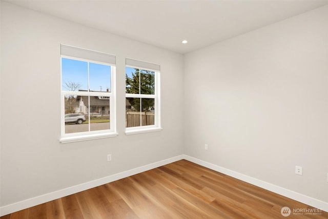 unfurnished room with recessed lighting, light wood-style floors, and baseboards