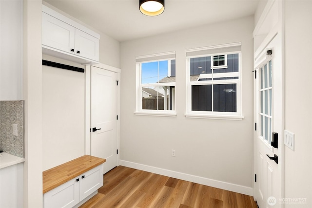 mudroom featuring light wood-style flooring and baseboards