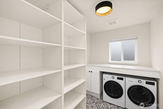 laundry area featuring washing machine and clothes dryer, laundry area, and visible vents