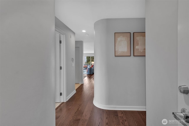 hall with baseboards and dark wood-style flooring