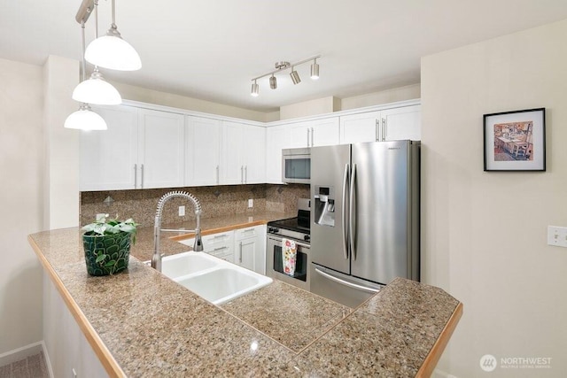 kitchen with a sink, stainless steel appliances, tile counters, white cabinetry, and tasteful backsplash