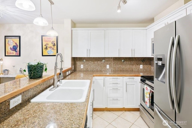 kitchen with white cabinetry, light tile patterned floors, appliances with stainless steel finishes, and a sink