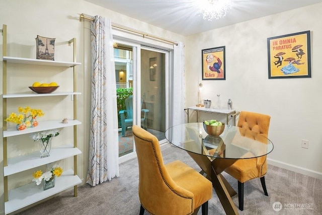 carpeted dining area with baseboards