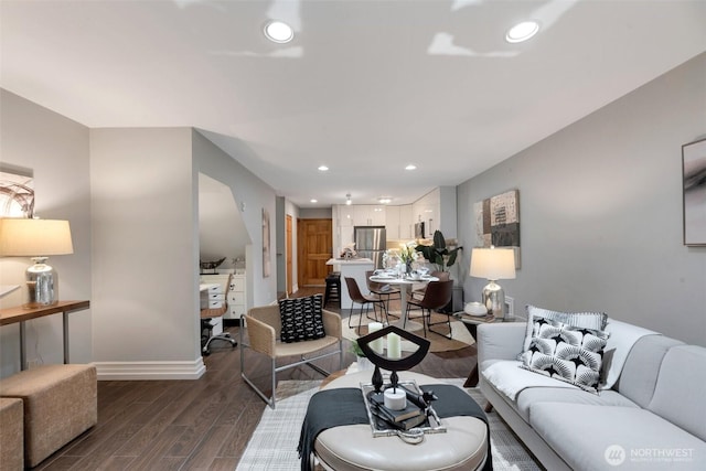 living area with recessed lighting, baseboards, and dark wood-type flooring