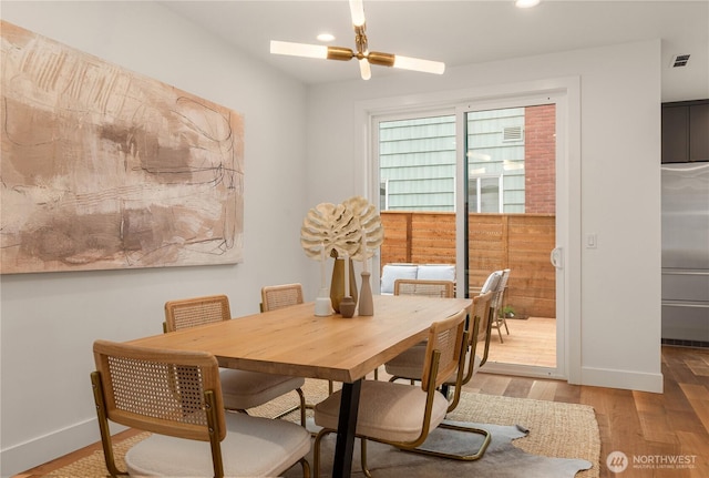 dining space with light wood-style flooring, recessed lighting, baseboards, and visible vents