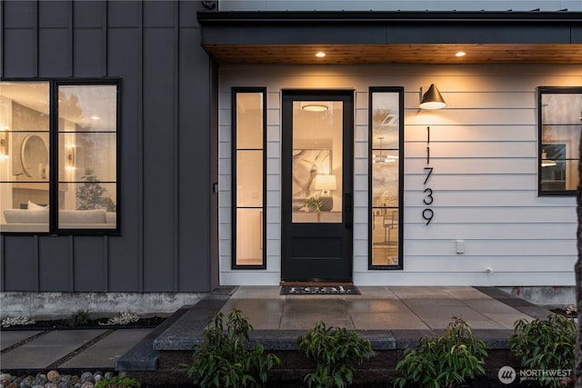 property entrance featuring board and batten siding