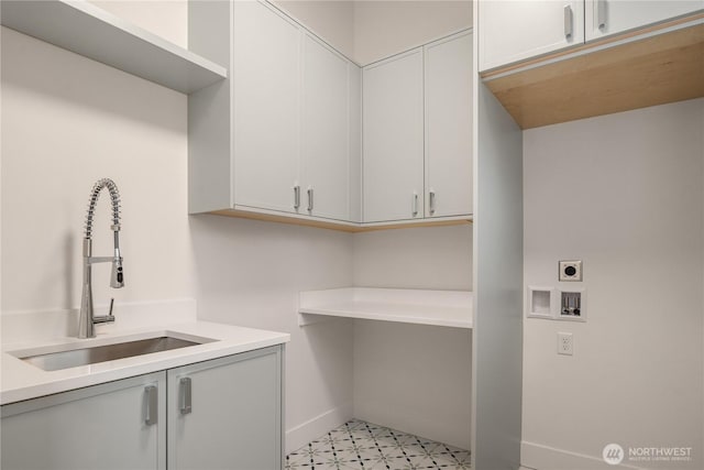 washroom featuring light floors, hookup for a washing machine, cabinet space, hookup for an electric dryer, and a sink