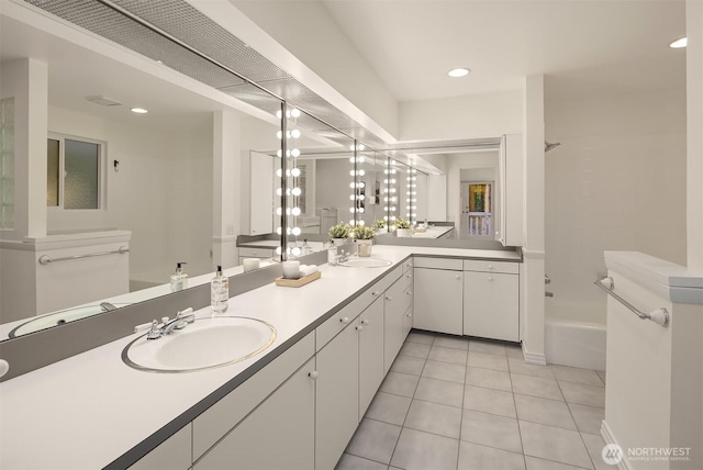 full bath featuring tile patterned floors, double vanity, and a sink