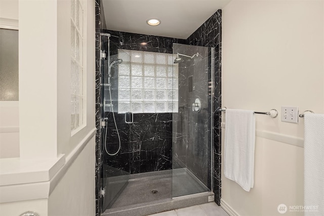 full bathroom featuring a marble finish shower