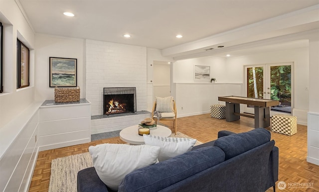 living room with recessed lighting, a fireplace, baseboards, and french doors