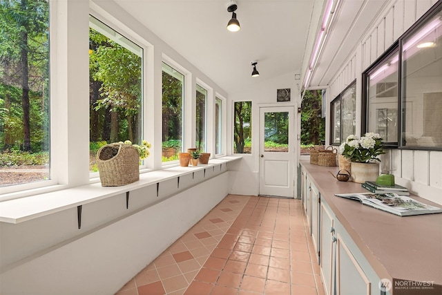 sunroom / solarium featuring vaulted ceiling