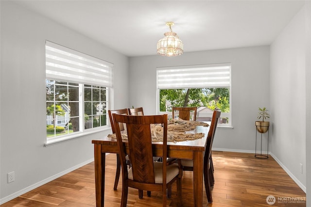 19013 112th Pl SE, Renton, WA 98055 - dining space with healthy amount of natural light, a chandelier, and wood finished floors