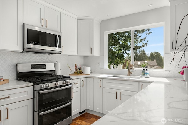 19013 112th Pl SE, Renton, WA 98055 - kitchen featuring appliances with stainless steel finishes, a sink, light stone countertops, white cabinetry, and recessed lighting