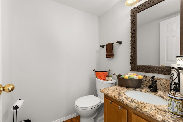 19013 112th Pl SE, Renton, WA 98055 - bathroom with toilet, vanity, wood finished floors, and baseboards