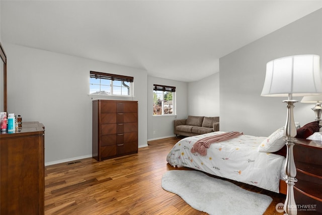 19013 112th Pl SE, Renton, WA 98055 - bedroom featuring wood finished floors, vaulted ceiling, and baseboards
