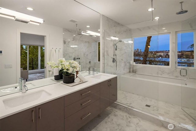 bathroom with a sink, a marble finish shower, marble finish floor, and double vanity