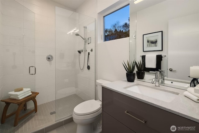 bathroom with tile patterned flooring, a stall shower, toilet, and vanity