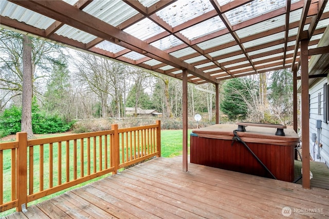 wooden terrace with a yard and a hot tub