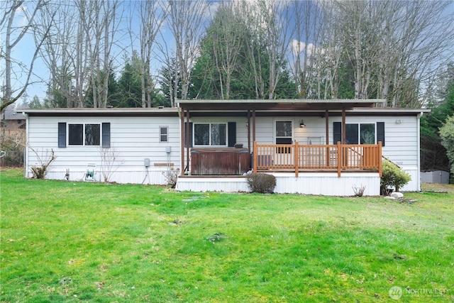 view of front facade featuring a hot tub and a front yard