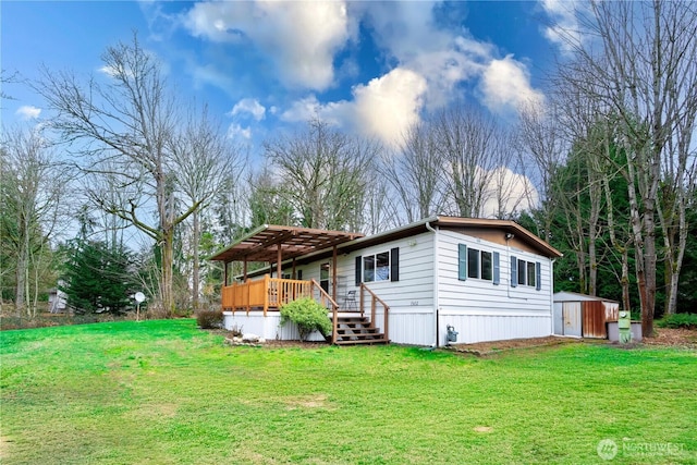 exterior space featuring a deck, an outdoor structure, a yard, and a shed